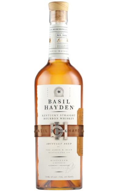 A delicate glass of light golden bourbon in soft warm evening light