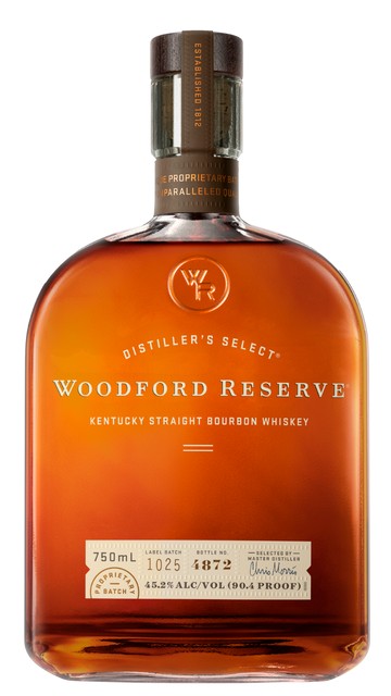 An elegant glass of polished amber bourbon under warm spotlight