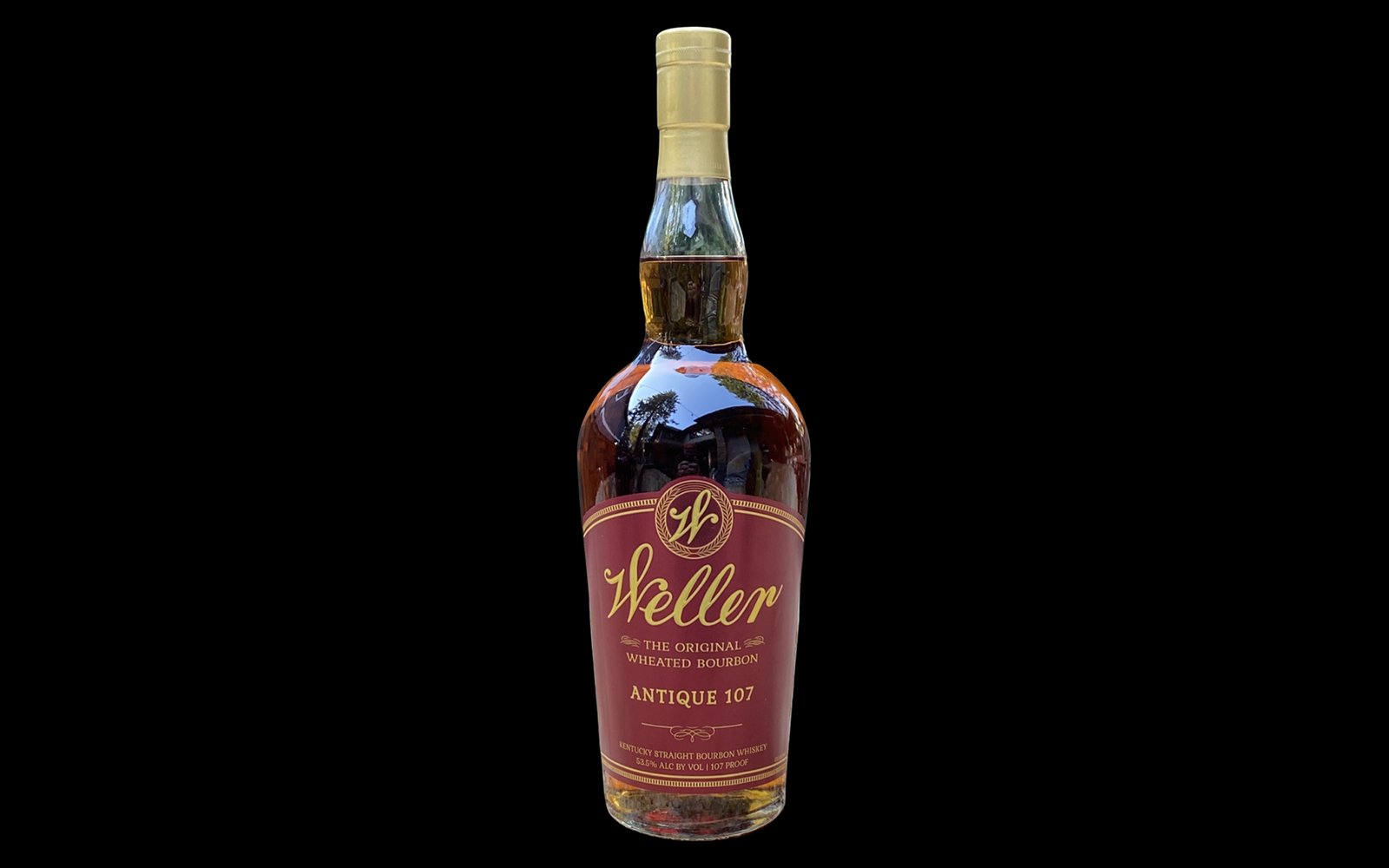 W.L. Weller Antique 107 bourbon bottle on a black background